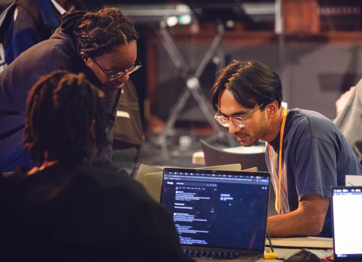 Builders working through code together at a past BUILD weekend