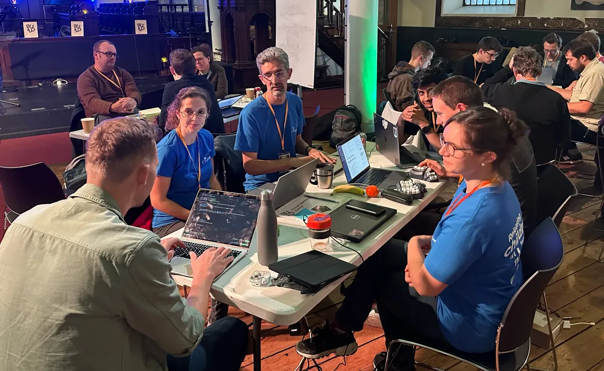 Teams working at tables in the main hall at a past BUILD weekend