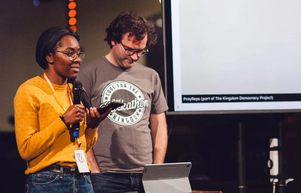 Builders presenting their project on stage at a past BUILD weekend